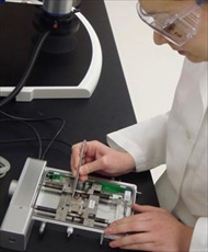 Graduate student, Erika Rodriguez, loads a sample in the Linkam TST350 tensile stage